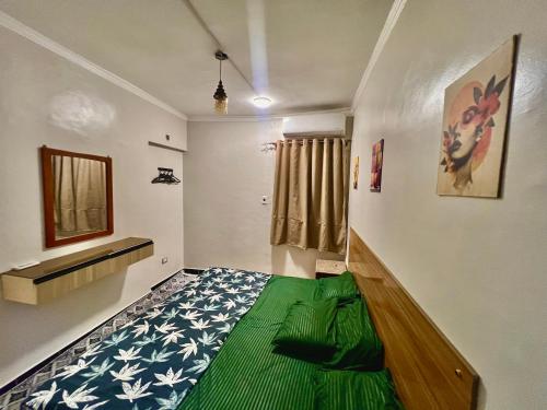 a bedroom with a green bed in a room at Super Elite apartment - Aswan city center apartments in Aswan