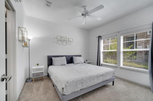 a white bedroom with a bed and a window at Stay at Universal Studios - Epic Area in Orlando