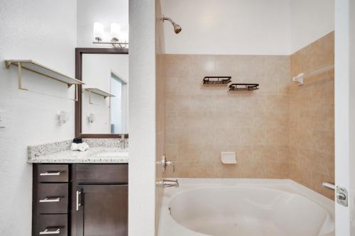 a bathroom with a tub and a sink at Stay at Universal Studios - Epic Area in Orlando