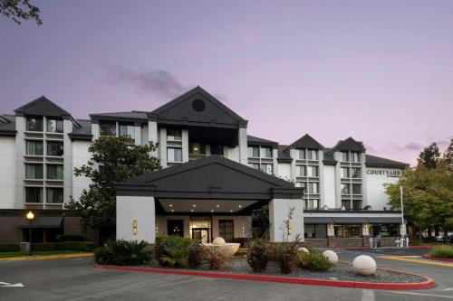 a large white building with a black roof at Courtyard by Marriott Santa Rosa in Santa Rosa