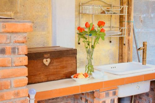 a vase of flowers on a counter next to a sink at Spacious view house 2BR in Thôn Châu Chữ