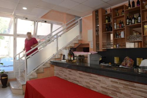 a woman standing at a counter in a restaurant at Motel Edem in Mostar