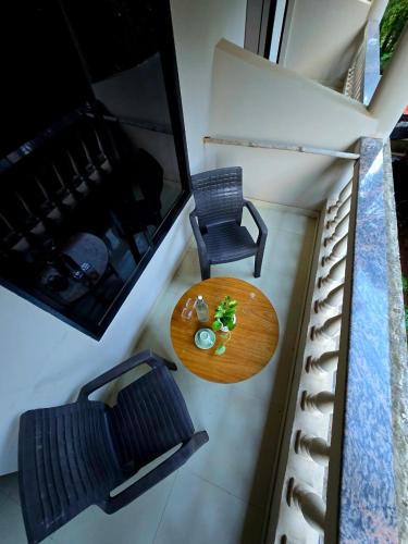 a table and a chair in a tiny house at The Twelve Palm Resort in Morjim