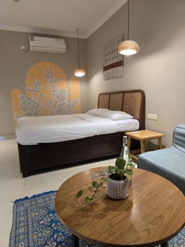 a hotel room with a bed and a table with a couch at The Twelve Palm Resort in Morjim