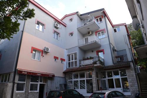 a large white building with red accents at Motel Edem in Mostar