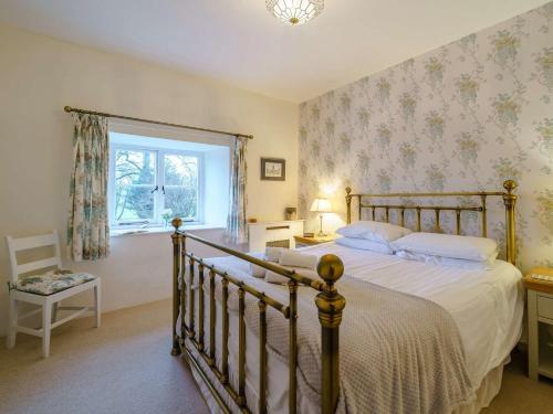 a bedroom with a large bed and a window at 2 Bed in Hawkshead Village LLH35 in Hawkshead