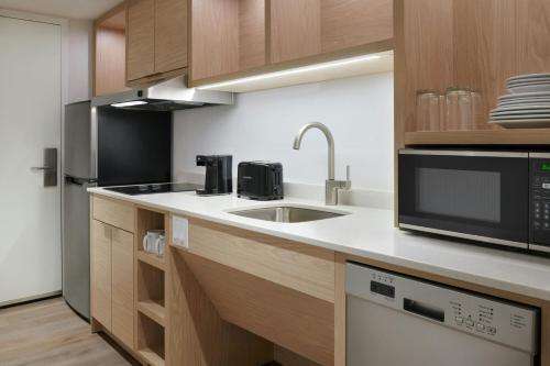 a kitchen with a sink and a microwave at TownePlace Suites by Marriott Niagara Falls Canada in Niagara Falls