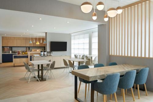 a dining room and kitchen with tables and chairs at TownePlace Suites by Marriott Niagara Falls Canada in Niagara Falls