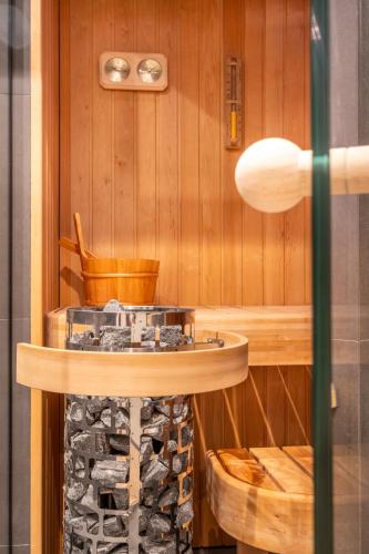 a sauna with a table and a pile of wood at Four Stories in Scheveningen