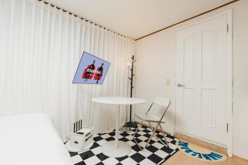 a room with a table and a checkered floor at Near Hongdae Station, 30sec on foot in Seoul