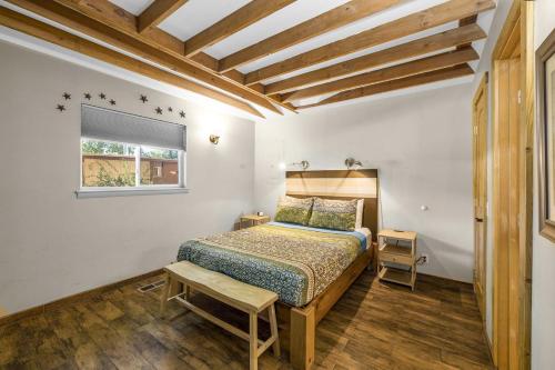 a small bedroom with a bed and a window at Creekside 61 East - 2BR in Moab