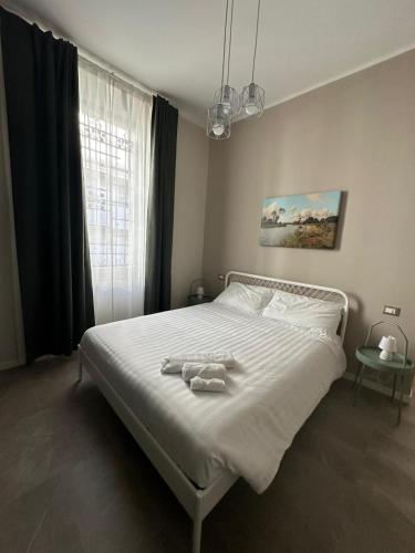 a bedroom with a bed with two towels on it at Villa Demetrio Ars Hotel in Piacenza