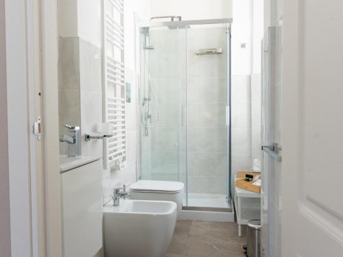 a bathroom with a shower and a toilet and a sink at Villa Demetrio Ars Hotel in Piacenza