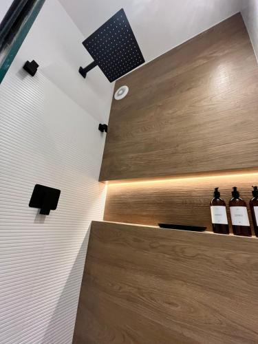 a room with bottles of wine on a shelf at Flat Praia Comfort Camburi in Vitória