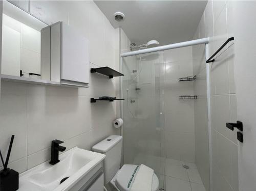 a white bathroom with a shower and a toilet at Apartment in Osasco in Osasco