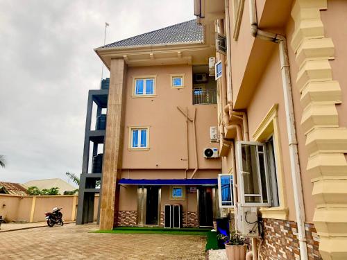 a building with blue windows on a street at Skyflix Hotel & Suites in Agbara