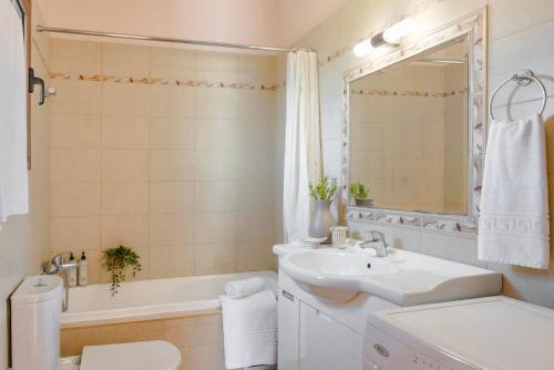 a bathroom with a sink and a tub and a toilet at Spartia Bay Cottage by Vintage Travel in Spartia