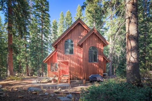 a red cabin in the middle of a forest at Cabin on the Edge of Forever in Brighton