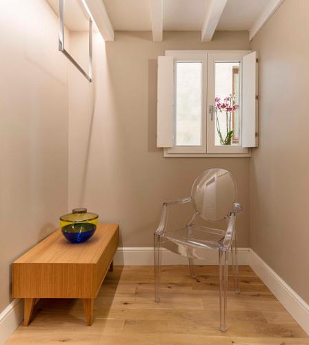 a dining room with a chair and a table and a window at BSJ15-Borgo San Jacopo Room in Florence