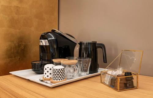 a tray with a coffee maker on a table at BSJ15-Borgo San Jacopo Room in Florence