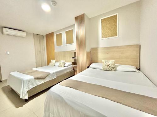Giường trong phòng chung tại Hotel Grand Horizon Rodadero, Santa Marta