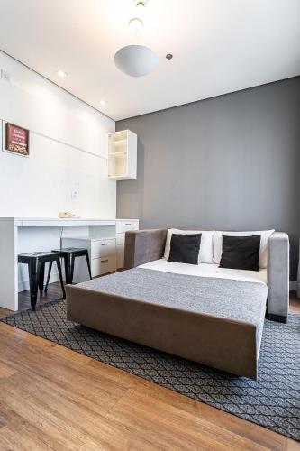 a bedroom with a large bed and a table at Flat Parque do Ibirapuera - Jardins in Sao Paulo