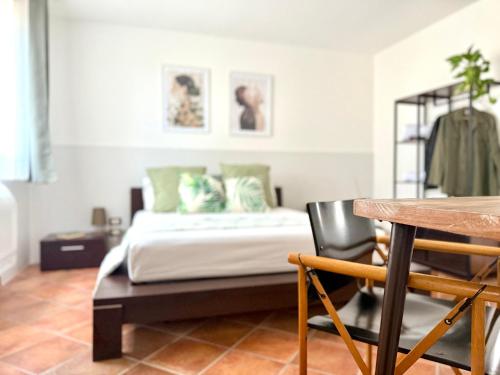 a bedroom with a bed and a table and chairs at Villa Demirà - Sky&Pool - Rooms in Marsala