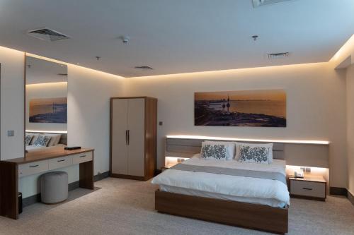 a bedroom with a large bed and a large mirror at Sara Plaza in Kuwait