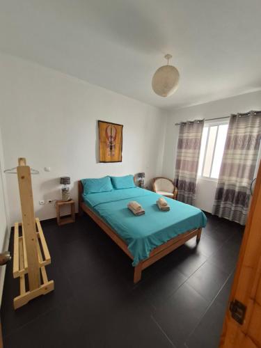 a bedroom with a bed and a ladder in it at Apart Laginha Tess & To in Mindelo