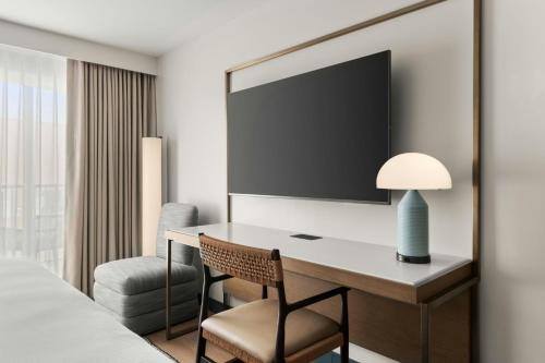 a desk in a hotel room with a bed and a chair at The Seahaus Hotel, Atlantic City Boardwalk, a Tribute Portfolio Hotel in Atlantic City