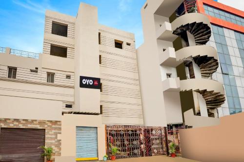 a building with a qop sign on it at Hotel O Woodlands in Kurnool