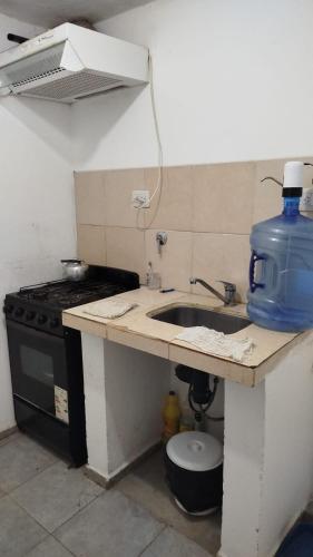 eine Küche mit Spüle und Herd in der Unterkunft Laboulaye, Sarmiento 334 in Laboulaye