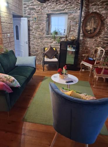 a living room with a couch and a table at Casa do Vale Encantado in Cedovim