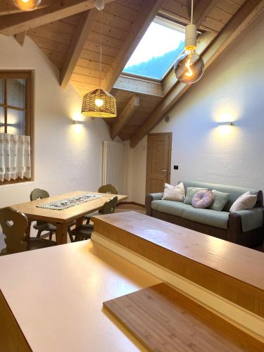 a living room with a couch and a table at Mansarda Ai Tigli in Castello di Fiemme