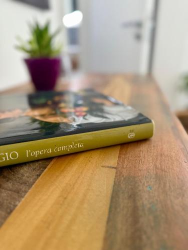 a book sitting on top of a wooden table at Villa Demirà - Sky&Pool - Rooms in Marsala