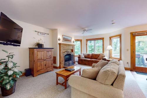 a living room with a couch and a tv at Grammy Jay Getaway #V363 in Jay