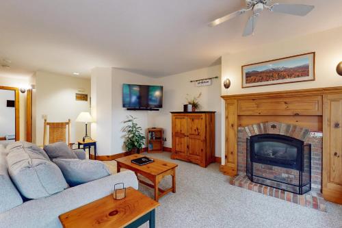 a living room with a couch and a fireplace at Grammy Jay Getaway #V363 in Jay