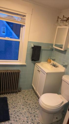 a bathroom with a white toilet and a window at My Kingdom in Everett
