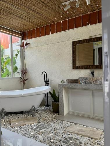 a bathroom with a tub and a sink at Villa Valber in Aga