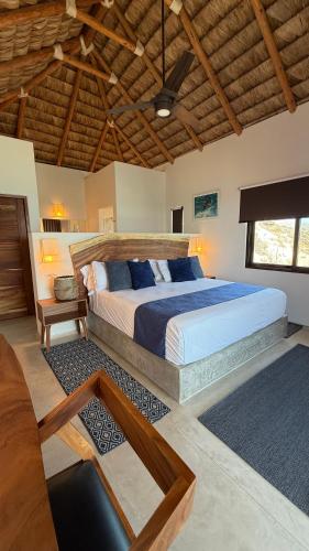 a bedroom with a large bed and a wooden ceiling at Azul Beach Kite Resort in El Sargento
