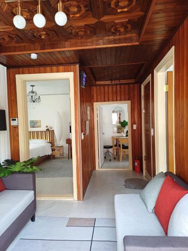 a living room with a couch and a bedroom at 어반 팀버 수원 in Hagwanggyo-dong