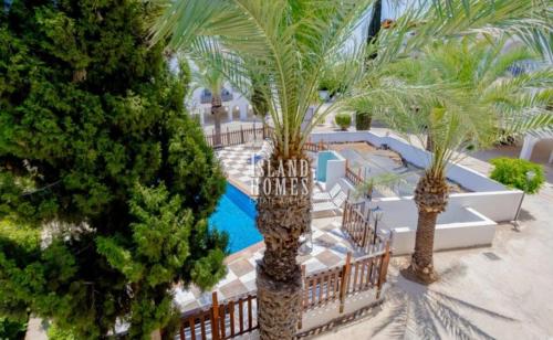 an aerial view of a resort with palm trees and a pool at D&D Apartment in Paralimni