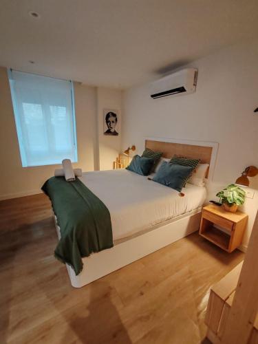 a bedroom with a large bed and a large window at TuApartamento Chapitela 16 by Clabao in Pamplona