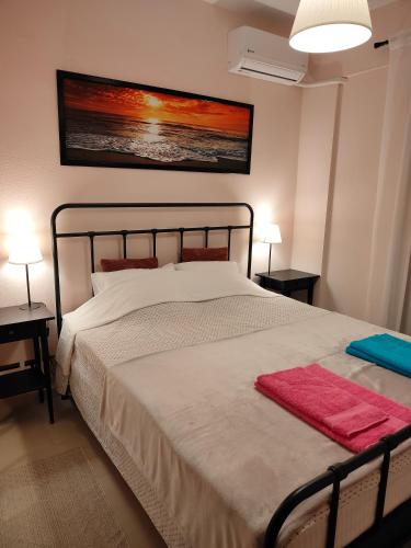 a bedroom with a large bed with a red blanket on it at SiviriLovelyApartment in Siviri