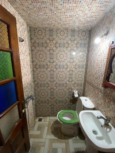 a bathroom with a toilet and a sink at Dar Merzouga Meknes in Meknès