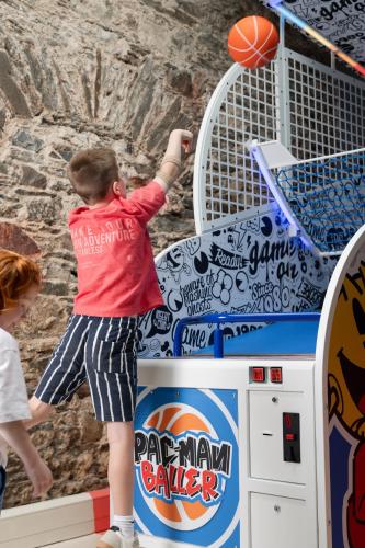 a young boy throwing a basketball into a basketball hoop at Roe Valley Resort in Limavady