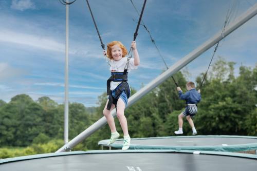 a little girl and boy on a trampoline at Roe Valley Resort in Limavady