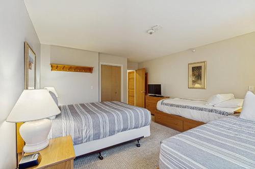 a hotel room with two beds and a lamp at Trailside Highlands #8 in Jeffersonville