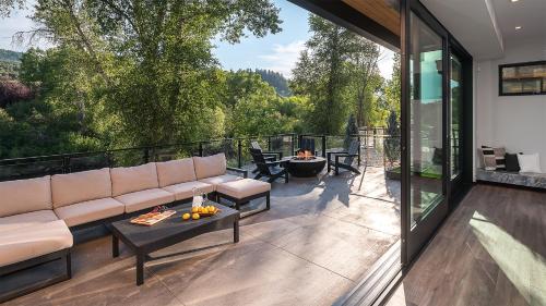 a living room with a couch and a table on a balcony at Triple 3 Lodge in Steamboat Springs