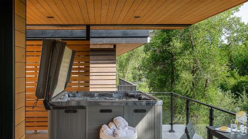 a outdoor grill on a deck with a table at Triple 3 Lodge in Steamboat Springs